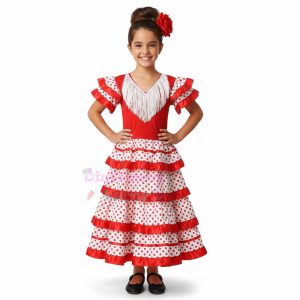 Niña con vestido de sevillana de color rojo y lunares blancos con volantes en la falda y mangas.